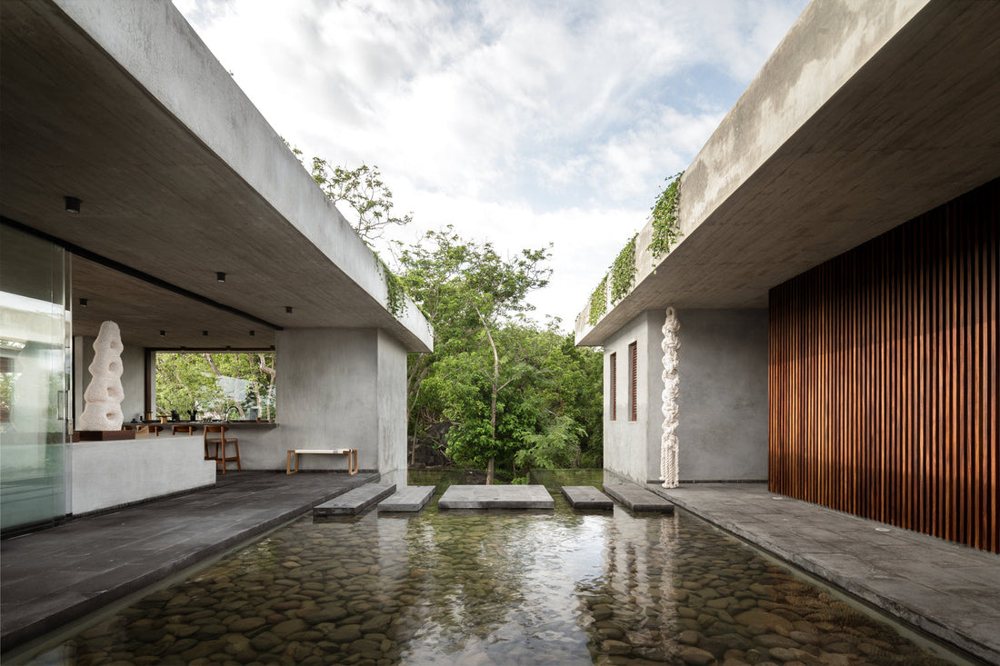 Water pond between living spaces in Mexico home