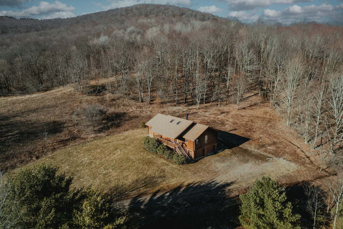 Aerial image of cabin in woods showing building orientation